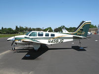 N458JG @ O41 - 1999 Raytheon Baron 58 in special Jaguar color scheme basks in May sunshine @ Woodland Aviation - by Steve Nation
