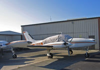 N6101X @ KRHV - Locally-based 1978 Cessna 310R with cockpit covered and in old (orange cheatline) color scheme poses in bright sunshine @ Reid-Hillview Airport, San Jose, CA