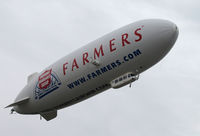 N704LZ @ KOAK - Airship Ventures dirigible in latest color scheme (Farmer's Insurance titles) climbing out from North Field @ Oakland International Airport, CA - by Steve Nation