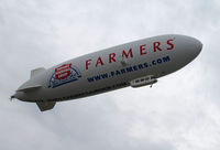 N704LZ @ KOAK - Airship Ventures dirigible in latest color scheme (Farmer's Insurance titles) climbing out from North Field @ Oakland International Airport, CA - by Steve Nation