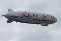N704LZ @ KOAK - Airship Ventures dirigible in latest color scheme (Farmer's Insurance titles) climbing out from North Field @ Oakland International Airport, CA - by Steve Nation