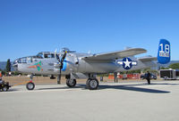 N125AZ @ KWVI - Commemorative Air Force Arizona Wing TB-25N 43-35972 blue tail #18 'Maid in the Shade' nose art being pushed back to display parking after demo flight @ 2010 Watsonville Fly-in - by Steve Nation