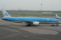 PH-BQH @ EHAM - The mighty 777 pushing back. Notice the high rise buildings in the horizon