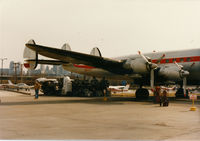 N6937C @ MKC - I believe the engines under the tail were to be installed on the aircraft. The gentleman in the tan jacket is a retired TWA Connie pilot who was kind enough to take me inside the aircraft.