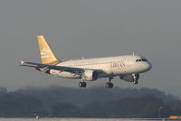 5A-LAH @ EGCC - Libyan Airways A320 on finals for RW05L - by Chris Hall