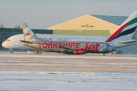 G-CELB @ EGCC - Jet2 B737 landing on RW05L as Emirates A380 taxies past - by Chris Hall