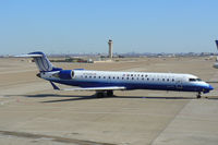 N756SK @ DFW - United Express pushing back from the gate at DFW Airport