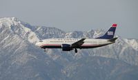N332AW @ ONT - Passing the snow capped peaks while on final to runway 26R - by Helicopterfriend