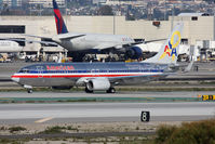 N905AN @ LAX - American Airlines Flagship Liberty N905AN (FLT AAL813) holding short of RWY 25R on Taxiway Papa after landing on RWY 25L from Austin-Bergstrom Intl (KAUS). This aircraft has a yellow ribbon on the tail and the text says In support of all who serve. - by Dean Heald