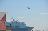 6022 - Coast Guard Helicopter at Castaway Cay in the Bahamas flying around the Disney Magic Cruise Ship. - by Bluedharma