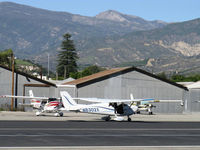 N8302X @ SZP - 1961 Cessna 172C, Continental O-300 145 Hp 6 cylinder, taxi to Rwy 22, passenger door removed. 6,704' Hines Peak in background - by Doug Robertson