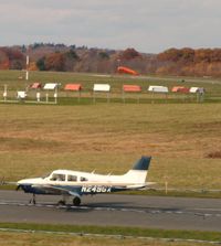 N2496X @ KBVY - Infront of wind sock on runway 27 at KBVY. - by Samuel D.