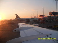 EI-IMI @ EHAM - Shortly after landing in Amsterdam, docking Gate B13 with nice sun rise in the background!