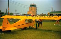 N850BJ @ KOSH - At Oshkosh 1987 with the old control tower in background - by Mark Peterson