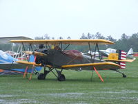 N1P @ KLAL - I had to check on Mark's Fleet, as the tornado had just rolled through... The rain was still torrential, but the old girl was still tied down OK.A few of the other vintage planes didn't do so good.