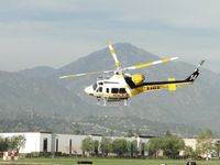 N14LA @ POC - After air taxiing on taxiway Coco, Copter 14 turns a sharp left at runway 26 to head westbound on a call for service - by Helicopterfriend