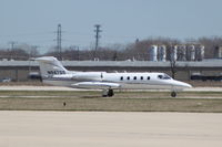 N947GS @ KDPA - Taxiing to Runway 2L.  Photographed through a chain-link fence. - by Glenn E. Chatfield