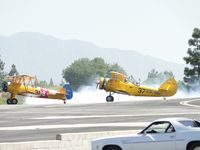 N5580M @ CCB - Looks like he's checking his smoke generator in front of N991PT - by Helicopterfriend