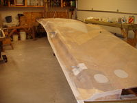 N3057K - Bottom of wing fabric laid out a first coat of polybrush. Top fabric wrapped around trailing edge, trimed and tacked down.