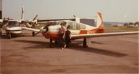N1093C - My brother John Rasor and myself, Jim Rasor, posing in front of our parents, William and Janice Rasor's Mooney. - by William Rasor