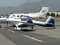 N410BW @ POC - Just parked in transient parking area and on the cell phone - by Helicopterfriend