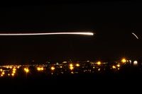 LX-LGS @ ELLX - Night arrival rwy 06, with the lights of Luxembourg-city and a Luxair EMB-145 in the background - by Raybin