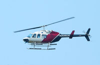 N206UH @ HRT - Passengers aboard this Bell Jet Ranger, N206UH, are inspecting high tension power lines east of Hurlburt Field, Fla. (an f-stop 5.6 photo) - by Bill Thornton