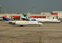 N904EV @ KATL - Delta N904EV advances away from the gates running alongside Air Tran N935AT at Atlanta. - by Doug Wolfe