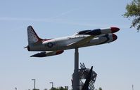57-0598 @ LAL - T-33 on a pole in Thunderbirds colors at a School next to Florida Aviation museum