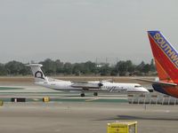 N418QX @ LAX - Allowed passengers to disembark, loaded new passengers and is taxiing to runway 24L for take off - by Helicopterfriend