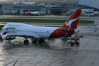 VH-OEH @ YSSY - loading in the rain - by Bill Mallinson