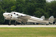 N2072 @ OSH - 1936 Lockheed 12A, c/n: 1208 arriving at 2011 Oshkosh - by Terry Fletcher