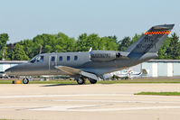 N606MG @ OSH - 1997 Cessna 525, c/n: 525-0231 unusual military scheme on a bizjet - by Terry Fletcher