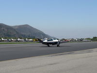 N5619K @ SZP - 1964 Beech S35 BONANZA, Continental IO-520-B 285 Hp, taxi off the active - by Doug Robertson