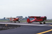 N270Y @ KDPA - Departing in formation for the EAA Convention. Piloted by Richard Perry.  Trail is N44562, piloted by Richard Hansen. 35mm slide - by Glenn E. Chatfield