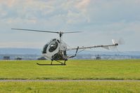 G-DCBI @ EGGP - Hovering over taxiway A1 post flight returning to general aviation (with a few fancy moves en route). - by Mark J Kopczewski
