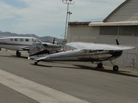 N195DK @ CNO - Parked by a hanger - by Helicopterfriend