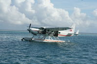 VH-PGT - VH-PGT Cessna 208 at rest on the Great Barrier Reef, Australia - by Pete Hughes