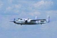 N25NA @ KDPA - Flying over Runway 1L - by Glenn E. Chatfield