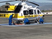 N110LA @ POC - After re-fueling, Crew assembles the Kawak Industries auxiliary hydraulic power system  snorkel - by Helicopterfriend