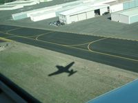N9490P @ POC - Shadow of ship seen between runway 26R and taxiway November - by Helicopterfriend