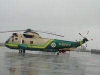 N950DG @ POC - Setting on the pad waiting for a call out in the rain - by Helicopterfriend