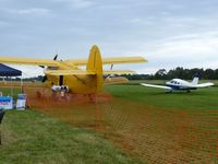 VH-CCE @ YLIL - Compare the size of the An-2 with the Piper Warrior beside it. The wing shadows prove how close they are, so it's not an optical illusion.