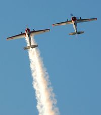 G-YAKF @ EGFH - With smoke on. In formation aerobatic practice with G-BVVA. - by Roger Winser