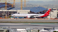 VH-VPH @ KLAX - Virgin Australia being towed to remote parking for its late departure. - by speedbrds