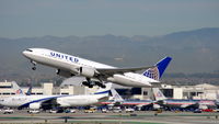N220UA @ KLAX - United Airlines with new livery along with El Al B772 in the background and the HOLLYWOOD sign clearly visible. - by speedbrds