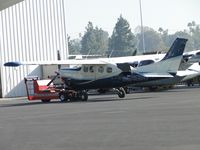 N242RY @ POC - Hooked up to a tug and parked at Howard Aviation - by Helicopterfriend