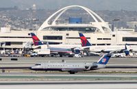 N963SW @ KLAX - United Express CRJ-200 with the Theme Building