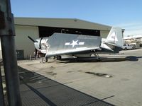 N7835C @ CNO - Has her fuselage tucked in the wings and being attended too at the Planes of Fame area - by Helicopterfriend
