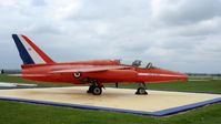 XP502 @ EGBP - XP502 / 02 (cn FL517) The Gnat is preserved in front of the control tower in Red Arrows colours to commemorate the fact that Kemble was the base for the Red Arrows during the fifteen years the team operated the type.
